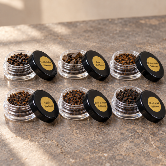 Six base bakhoor samples in clear jars with black labeled lids; kit includes six to eight samples